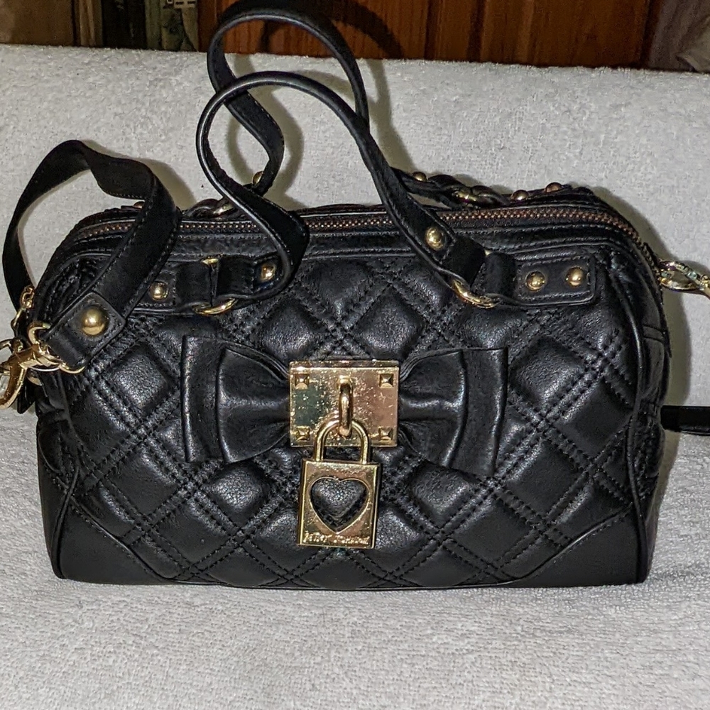 Betsey Johnson black leather quilted satchel bag.